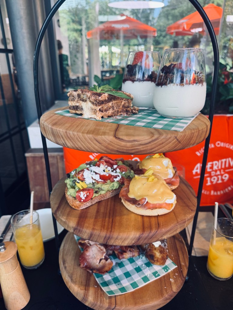 Served on a 3 storey high platter Maple granola with yoghurt & berry compote. Avocado & tomato salsa on sourdough with zaatar & bacon
Smoked salmon, poached egg, hollandaise. Fried sundried tomato & sweet potato risotto balls lightly crumbed, served with aioli

Tiramisu