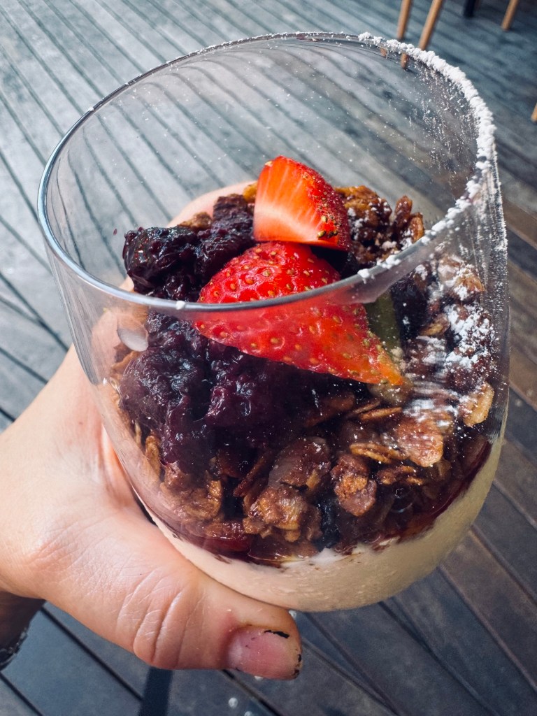 Maple granola with yogurt and berry compote in a glass