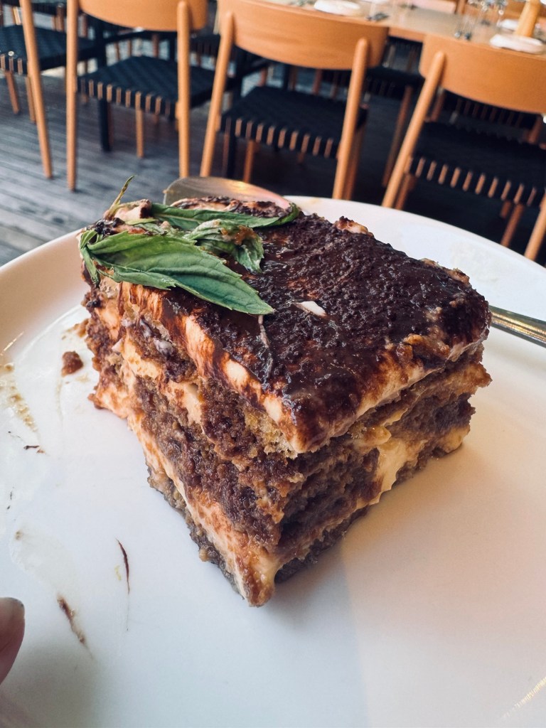 Tiramisu and mint on plate with spoon